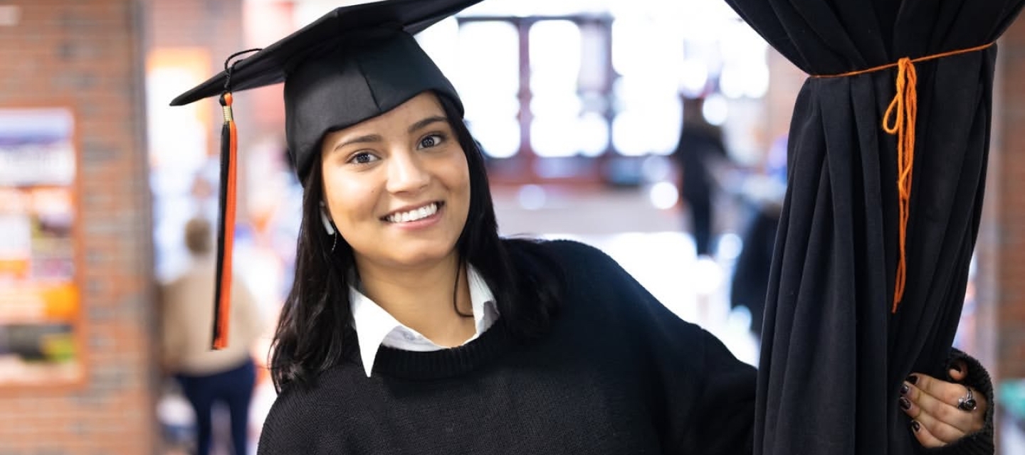 Student smiling in graduation cap