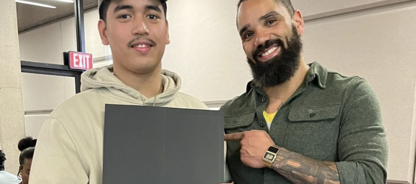 Student holding a certificate with success navigator Brad Benz