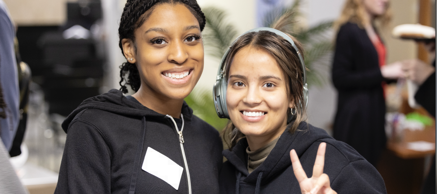 2 students smiling and posing infront of the camera